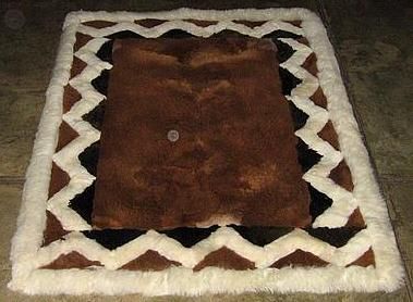 Brown alpaca fur rug with white patterns, different sizes