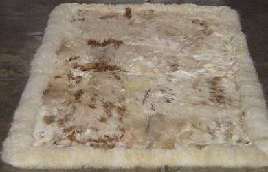 White baby alpaca fur rug with brown spots